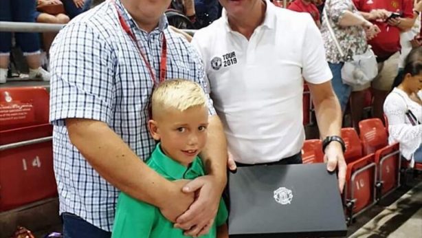 Colby and his dad receive a signed Paul Pogba shirt from United Legend Dennis Irwin