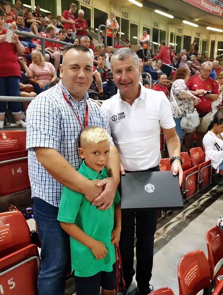 Colby and his dad receive a signed Paul Pogba shirt from United Legend Dennis Irwin