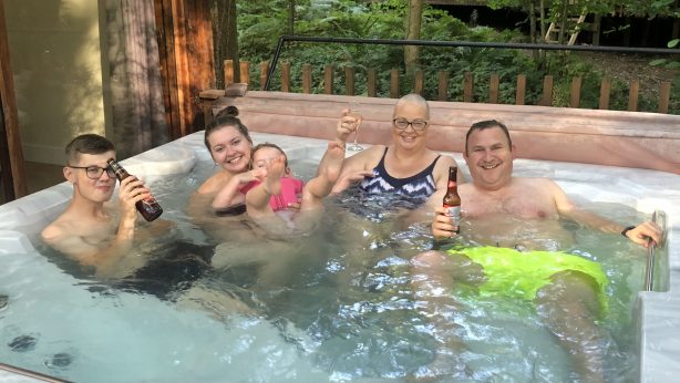 The family enjoying some quality time in the hot tub in their lodge at the Forest of Dean