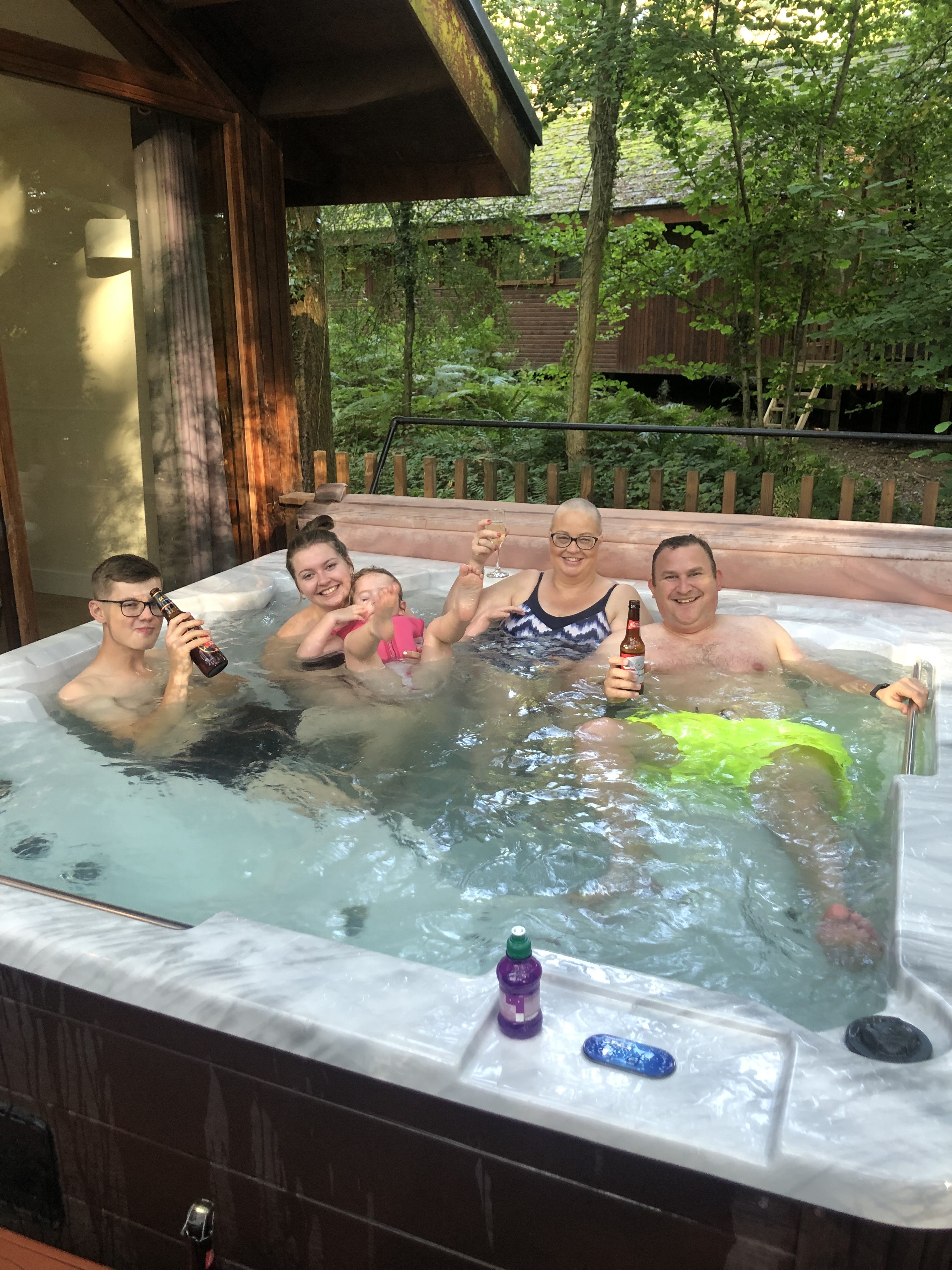 The family enjoying some quality time in the hot tub in their lodge at the Forest of Dean